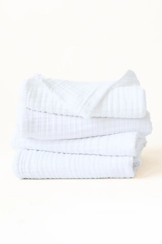 Stacked white muslin Turkish cotton towels showing the soft 4-layer gauze weave, handwoven in Denizli