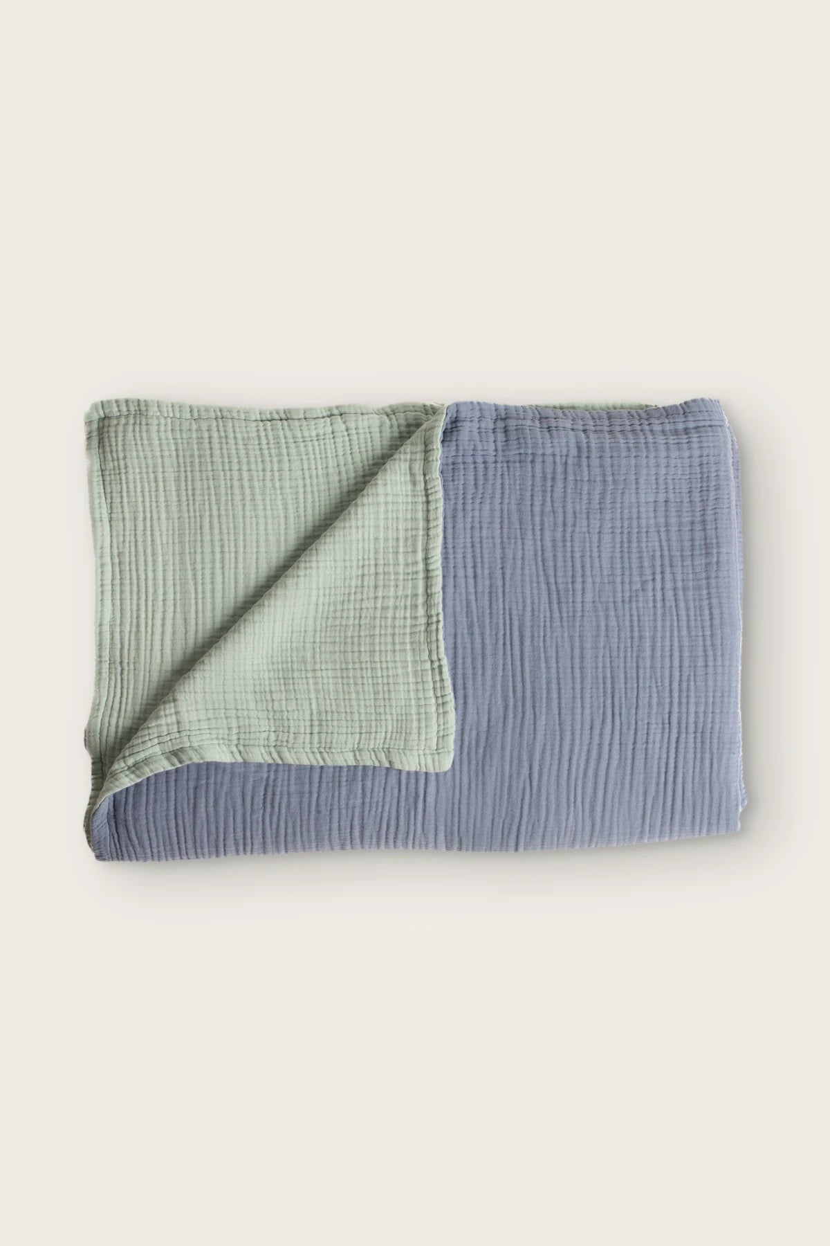 Reversible 8-layer muslin bedspread in hawaii blue / sage green, folded flat lay showing both sides