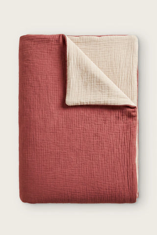 Reversible two-tone muslin duvet cover in terracotta / ecru, folded view showing both sides