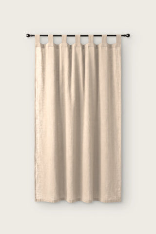 Stonewashed cotton curtain panel in beige, single tab top panel on a black rod, front view