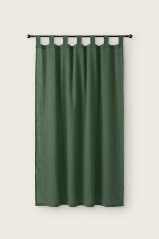 Stonewashed cotton curtain panel in dark green, single tab top panel on a black rod, front view
