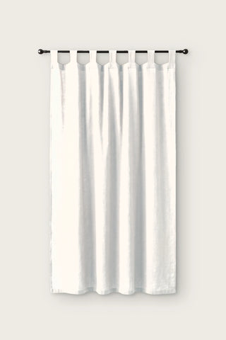 Stonewashed cotton curtain panel in white, single tab top panel on a black rod, front view
