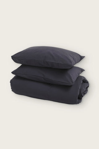 Stonewashed Turkish cotton duvet cover set in anthracite, folded duvet with two pillowcases, front view