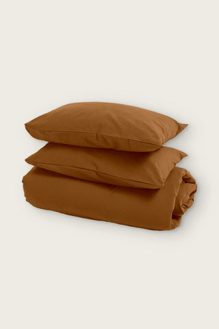 Stonewashed Turkish cotton duvet cover set in caramel, folded duvet with two pillowcases, front view