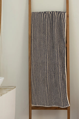 Navy striped Turkish cotton bath sheet hanging on a wooden ladder - VivaMaison
