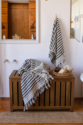 Anthracite White Turkish cotton mosaic towel in a bathroom, hanging and draped over a wooden chest - VivaMaison