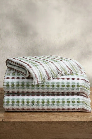 Sage Brown Turkish cotton mosaic towel stacked on a wooden bench - VivaMaison