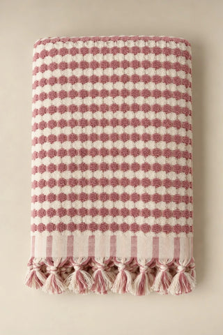 Pink Turkish cotton pom pom towel folded front view with bobble texture and knotted fringe - VivaMaison