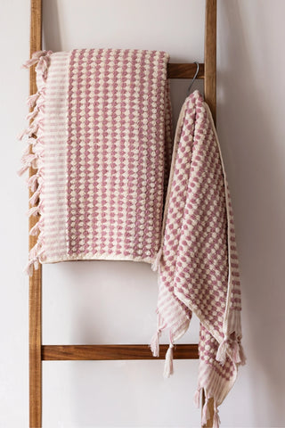 Pink Turkish cotton pom pom towel hanging on a wooden ladder - VivaMaison